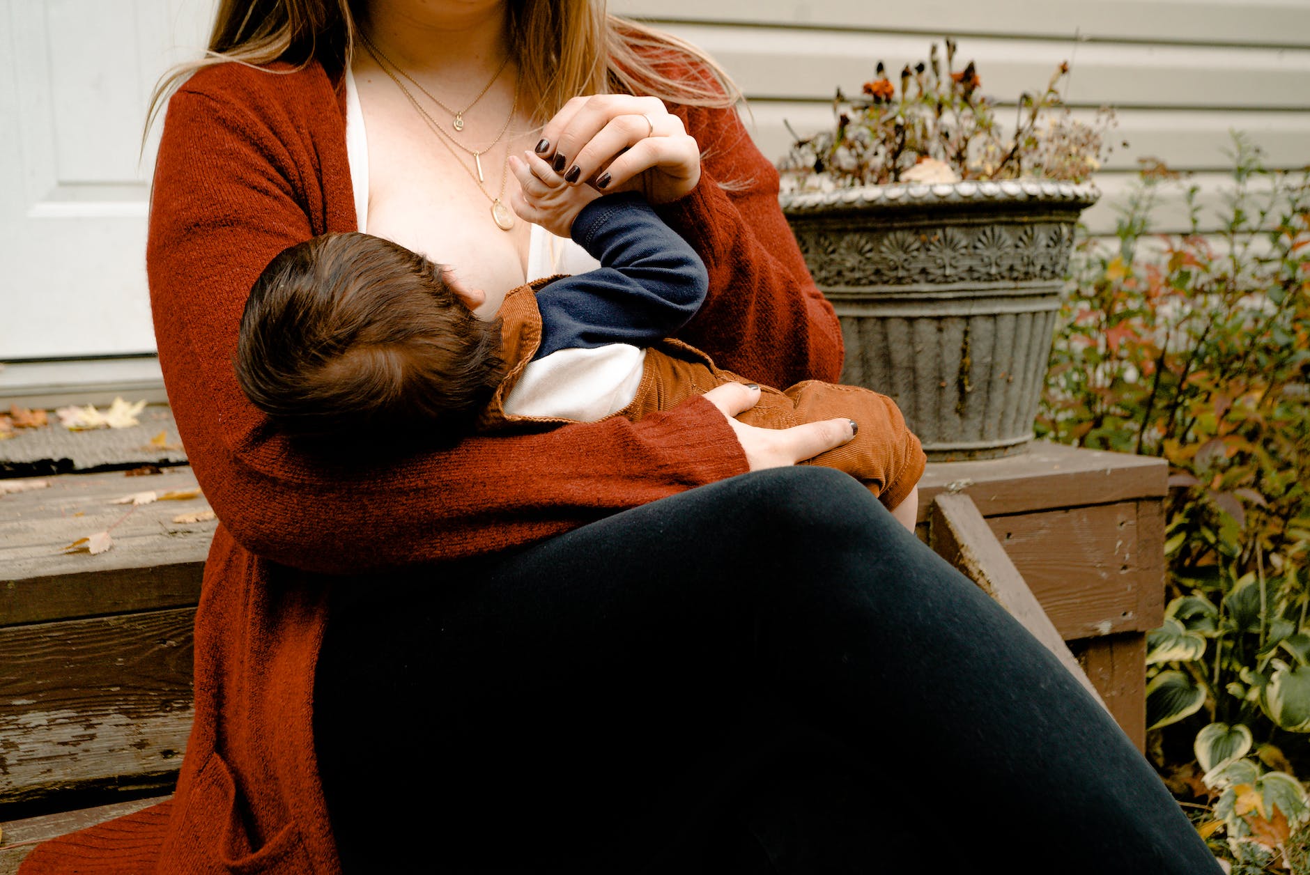 mother breastfeeding her child - how to breastfeed in public subtly